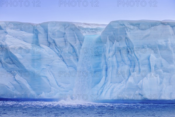 Waterfall at edge of the Brasvellbreen glacier from the ice cap Austfonna debouching into the