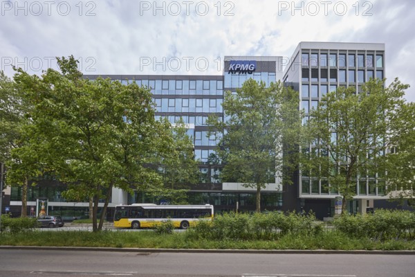 Auditing and management consultancy KPMG, modern architecture, street, public bus, trees, milky