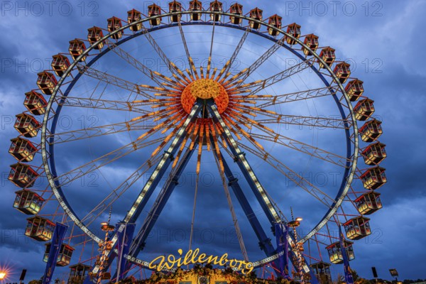 Dark clouds behind the illuminated Ferris wheel, Festwiese, Theresienwiese, Oktoberfest, Munich,