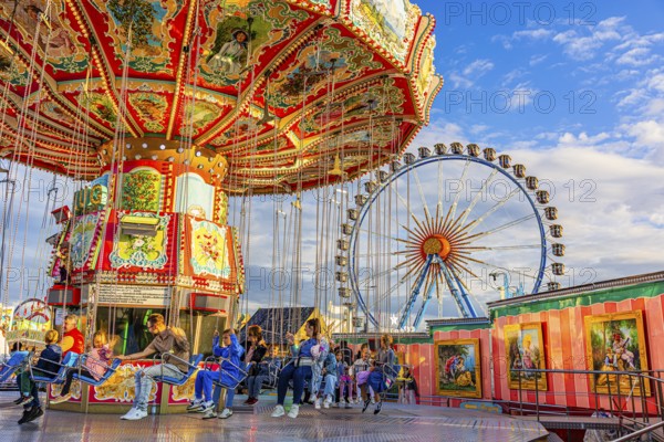 Chain carousel at a standstill, Ferris wheel in the background, Theresienwiese, Oktoberfest,