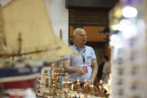 Syrian artisans display handmade artistic pieces to visitors at the Damascus International Fair.