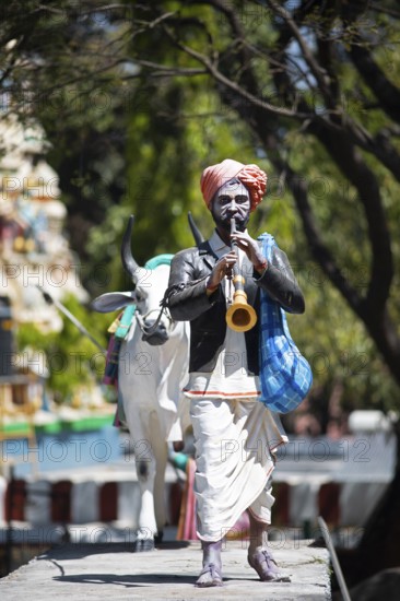 Statue of a farmer playing the shenai or traditional flute at the Hindu Basavanagudi Bull Temple,