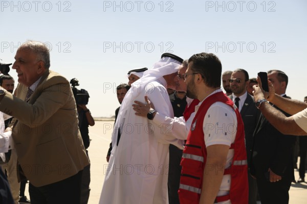 Officials from the Qatari and Syrian Red Crescents receive a Qatari airlift of aid to help the