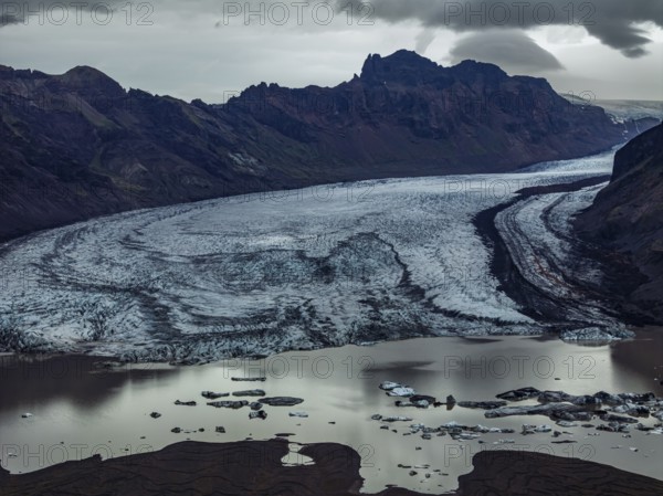 Glacier, glacier tongue, glacier lake, mountains, cloudy, aerial view, panorama, summer,