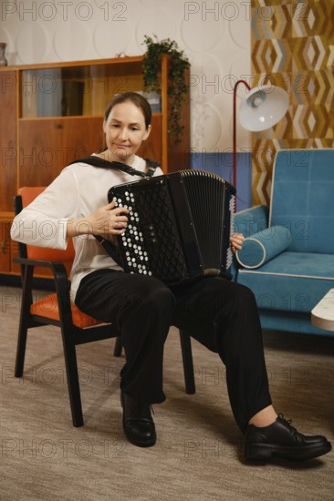 A middle-aged woman is seated comfortably in a vintage living room, skillfully playing the