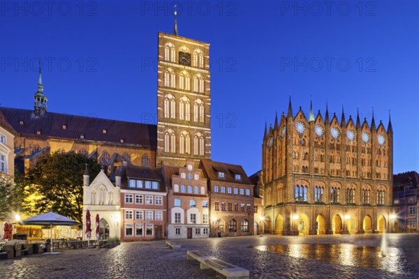 Night view, left back St. Nikolai Church first mentioned 1276, 102 metres high, front left, white,