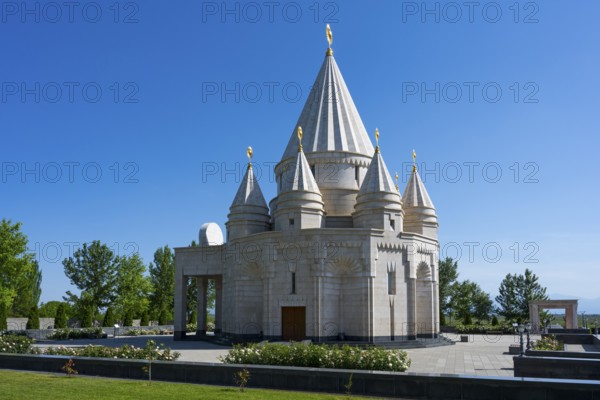 A modern sanctuary with multi-towered architecture under a clear blue sky, Yazidi temple, the