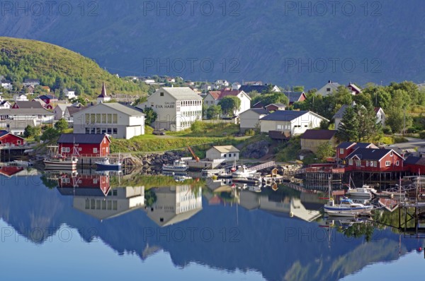 Small village with colourful houses and harbour facilities, picturesquely situated on the water,
