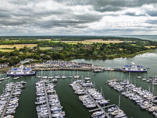 Wight Light car ferry to Isle of Wight on Lymington River and marina from drone, Lymington, New