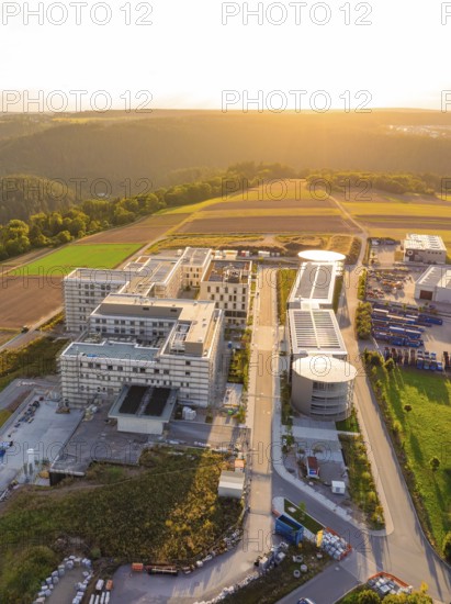 Compact aerial view of a modern building complex at sunset, new hospital building, Calw health