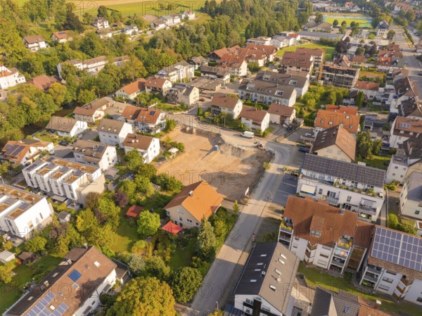 Quiet residential area with newly built area, surrounded by greenery and solar panels, small town