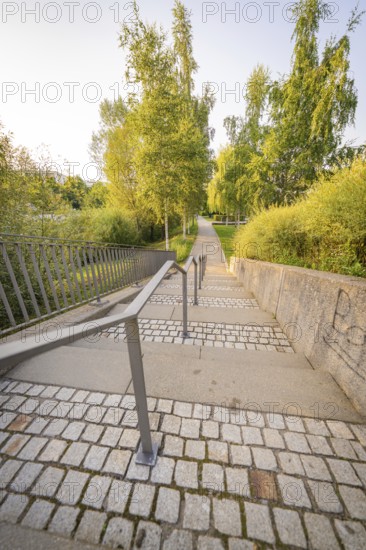 Stone staircase with metal railings, flanked by lush greenery, small town of Perle Nagold, Black