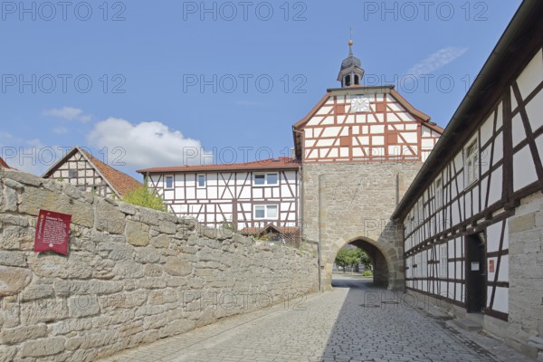 Historic Lower Tor with spire and clock and half-timbered houses, Tor tor, town gate, town wall,