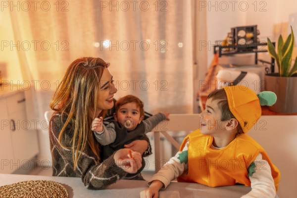 Happy family celebrating halloween together at home, wearing costumes and smiling, enjoying quality