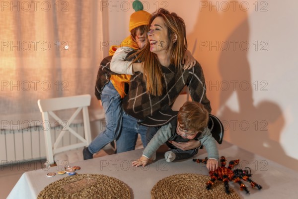 Happy family enjoying halloween festivities, wearing colorful costumes and playing joyfully