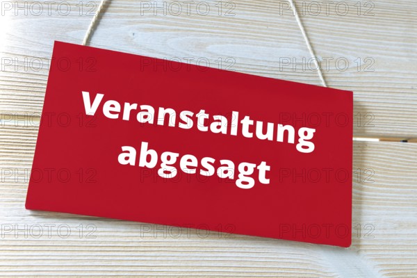 (Photomontage) Sign with text EVENT CANCELLED