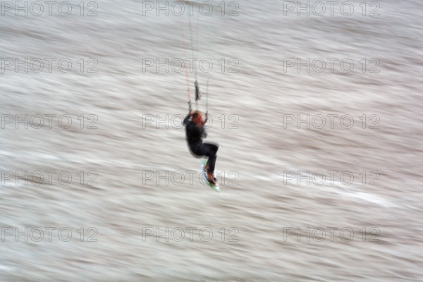 Kitesurfer jumping in the surf, wiping effect, long exposure, Sankt Peter-Ording, Eiderstedt