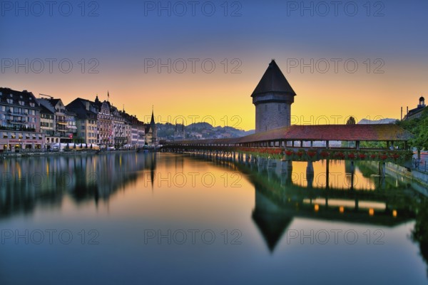 Chapel bridge with water tower reflected in the river Reuss, Lucerne old town at dawn, Canton