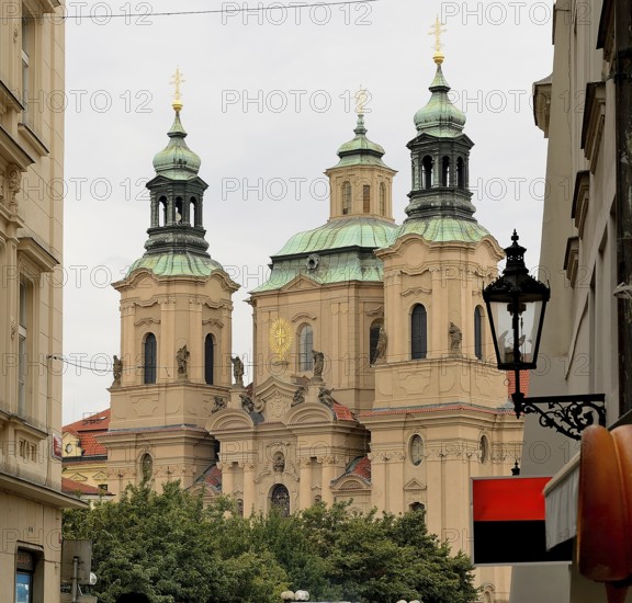 Church towers rising above the cityscape of prague, showcasing the city's rich architectural