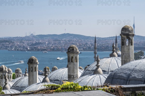 Traditional ottoman architecture dominates the foreground, with the bosphorus strait and the asian