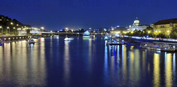 Vltava river reflecting the vibrant cityscape of prague, with boats sailing gracefully on a warm