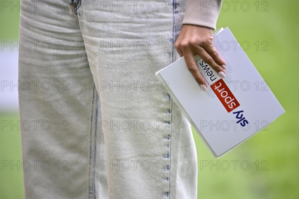 SKY presenter Mara Mones with presentation card Logo Detail Close-up Feature Voith-Arena,