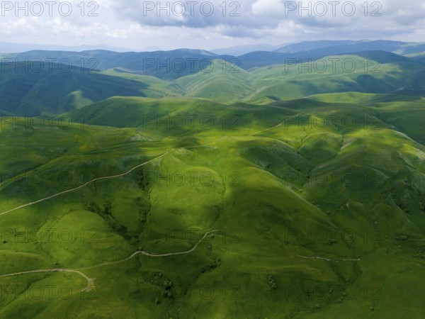 Green hills stretch under a cloudy sky, picturesque landscape, aerial view, Dilijan National Park,