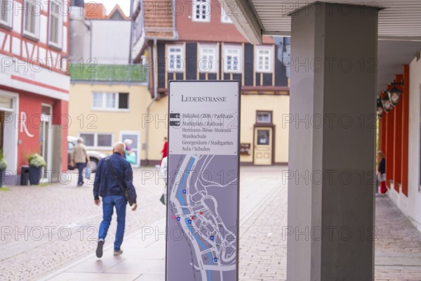 Detailed architecture with half-timbered houses and a walking man, small town of Perle Calw, Black