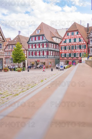 View of a picturesque market square with half-timbered houses in historical style, small town of