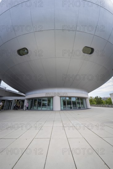 Dome-shaped modern building with prominent entrance area and architectural details, BMW Welt,