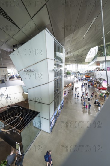 View from above of an exhibition space with many visitors and modern elements, BMW Welt, Munich,
