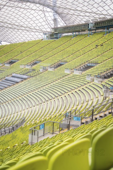 Detailed view of green rows of seats in a modern stadium with glass roof structure, Olympic Park,
