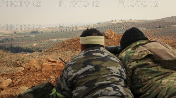 Syrian opposition fighters planning military strategies in preparation for clashes with ISIS.