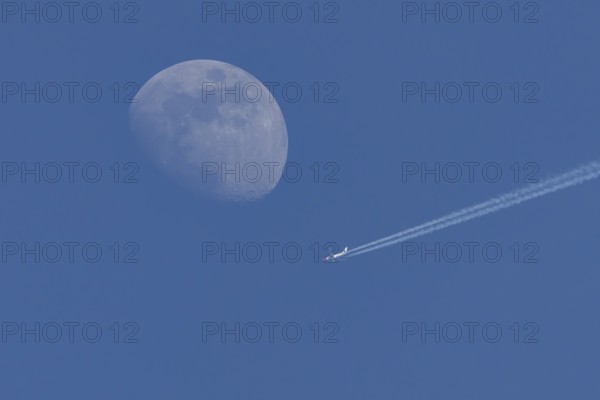 Boeing 737 jet passenger aircraft of Norweign Air with a vapour trial or contrail behind flying in