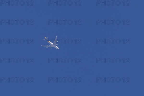 Boeing 747 jumbo jet cargo aircraft of UPS United Postal Service flying in a blue sky, England,