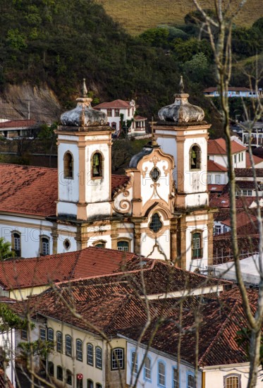 Church between the roofs of the colonial houses in the city of Ouro Preto in Minas Gerais, Ouro