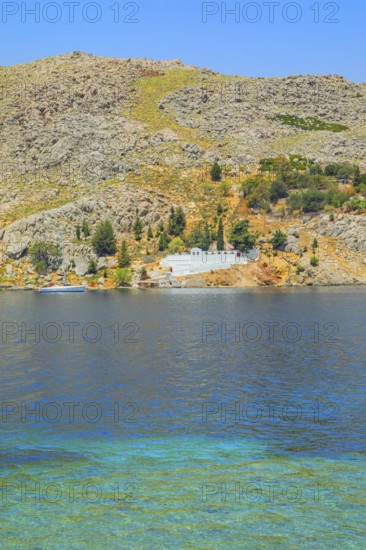 View of the ocean and monastery in the distance from Nimborio Beach, Nimborio, Symi Island,