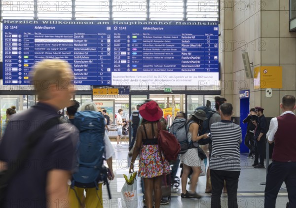 Mannheim main station, interior view with people and display board. Mannheim, Baden-Württemberg,
