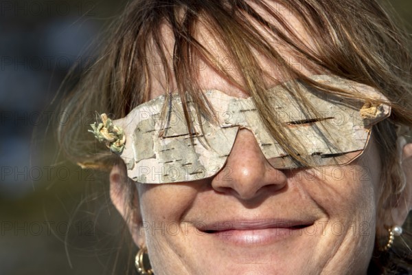 Woman wearing glasses made from birch bark, Gaspesie national park, Province of Quebec, Canada,