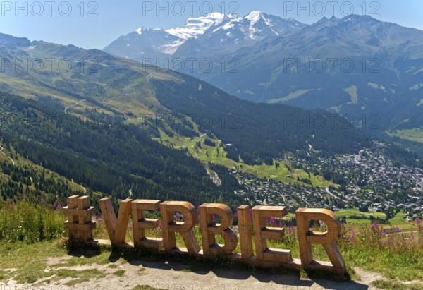 Lettering 'Verbier' in large wooden letters at a photo spot on the Col de la Croix de Cœur pass,