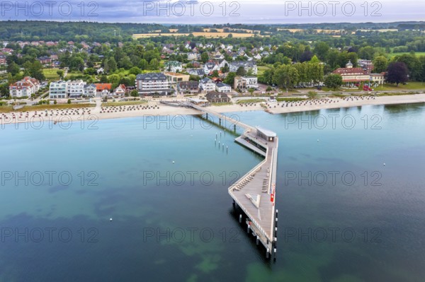 Aerial view over Seebrücke, pier and sandy beach at seaside resort Haffkrug along the Baltic Sea,