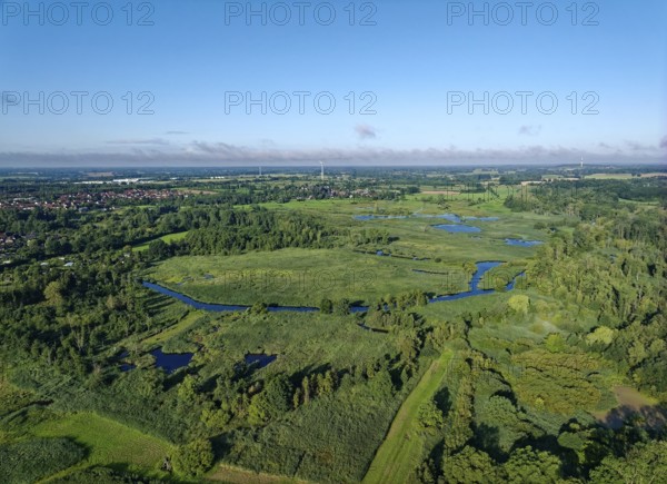 Water surfaces of the Trave and vegetation in the Brenner Moor. Aerial view. The Brenner Moor is a