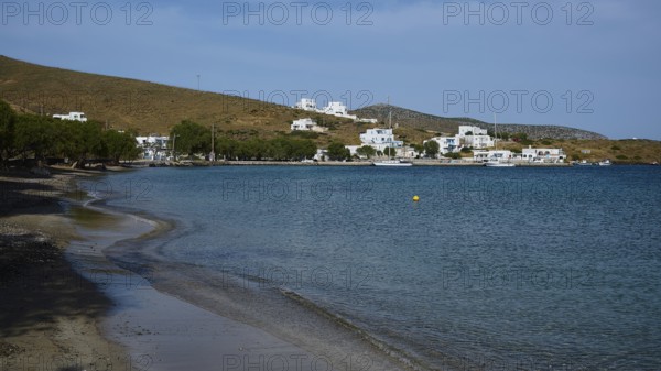 A secluded beach overlooking a coastal settlement and the calm sea, Analipsi, Maltezana, Astypalea,