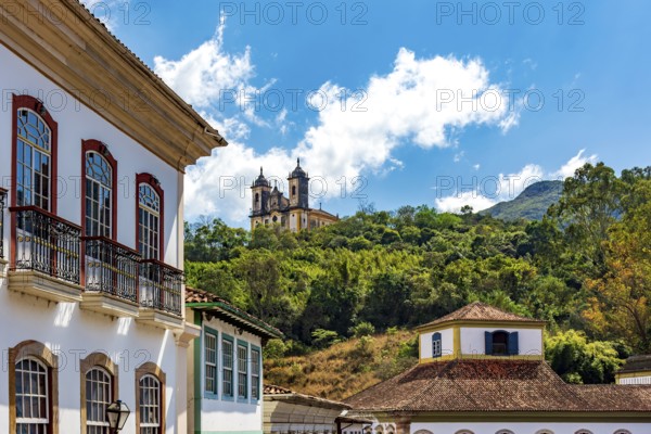 Facades of colonial houses and a baroque church in the historic city of Ouro Preto, Ouro Preto,
