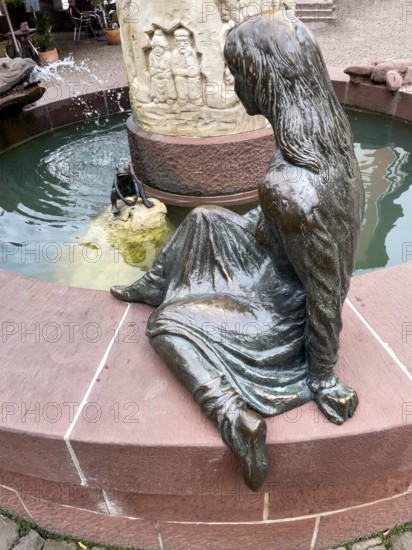 Sculptures figures of princess and frog holding golden ball representation from fairy tale the frog