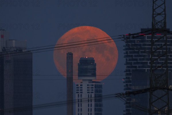 The full moon rises behind the Henniger Tower in Frankfurt am Main, Frankfurt am Main, Hesse,