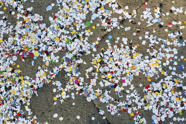 Confetti on asphalt, full-size, symbolic image, waste, environmental pollution, Carnival in Venice,