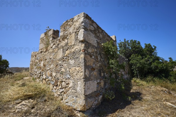 Old stone ruins with surrounding vegetation under a clear blue sky, Panagia tou Paleokastro, Church