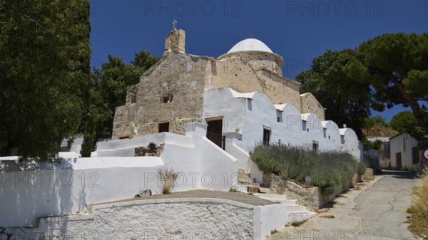 Whitewashed, stone church with dome and trees under a clear blue sky, basilica, church, Agios