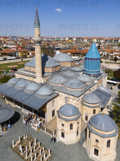 Detailed mosque with decorated dome and minaret in the background of the city view, aerial view,